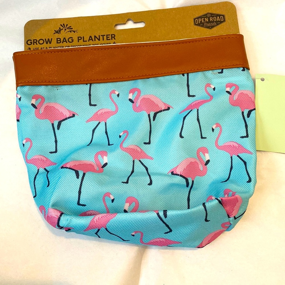 Cute pink flamingo grow bag. New with tags decorative pot cover or planter.